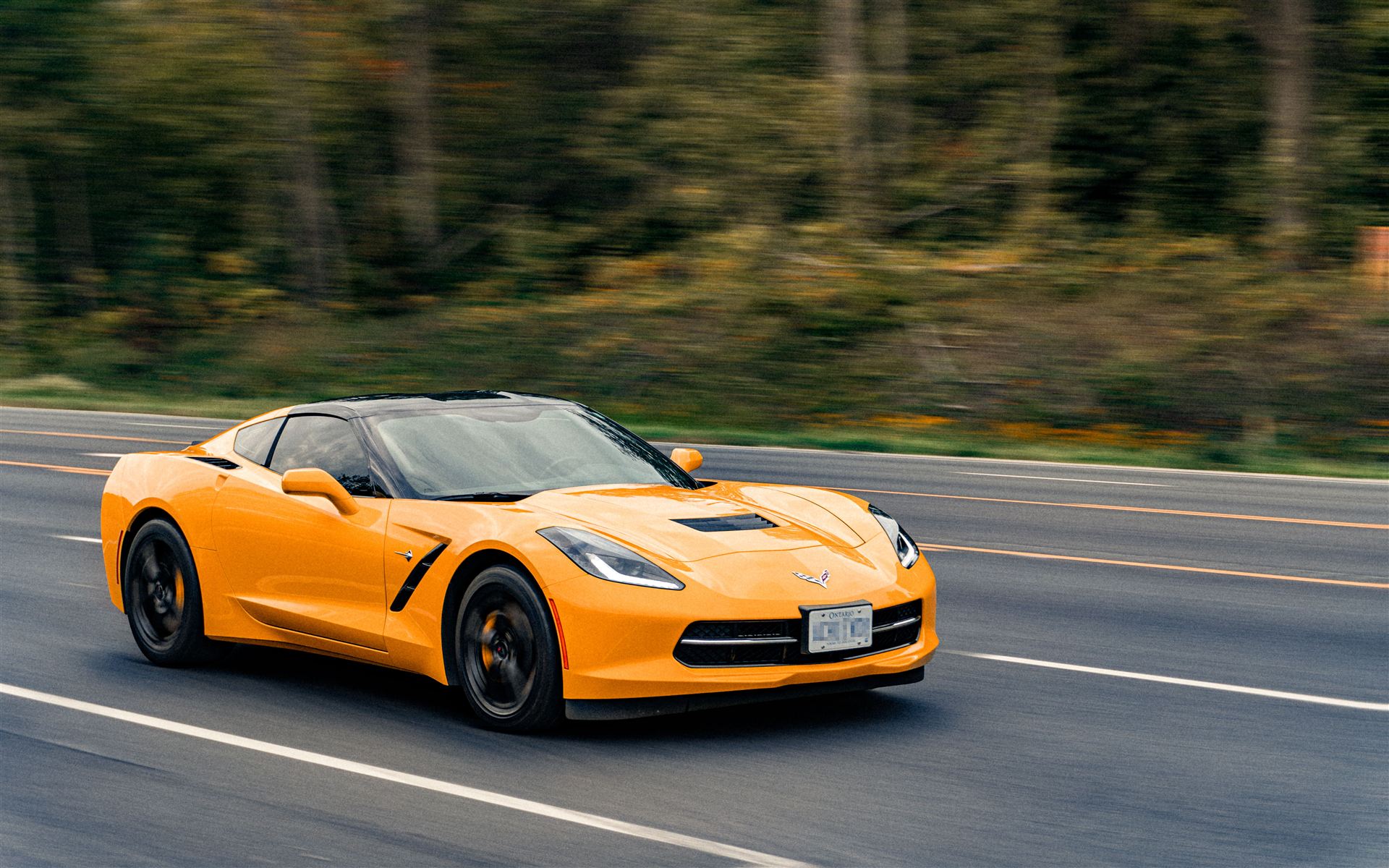 Sports car driving on an open road